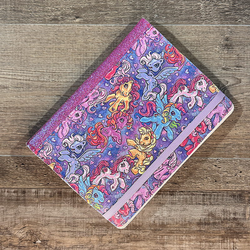 notepad holder featuring retro pony cartoon sketches